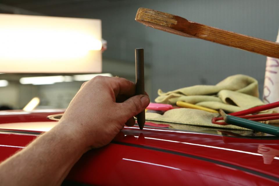 Mechanic working on a red car
